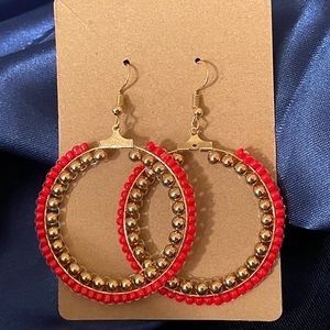 Handmade earrings in red and gold.